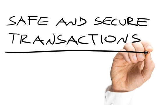 Male hand writing Safe and secure transactions