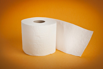 Simple toilet paper on yellow background