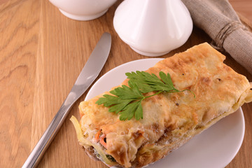 burritos wraps with meat beans and vegetables on wood board
