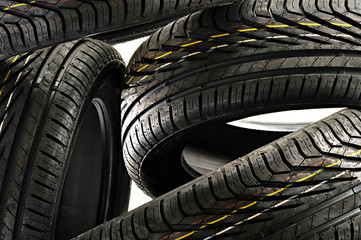 Four new black tires isolated on white