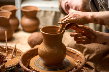 hands of a potter, creating an earthen jar