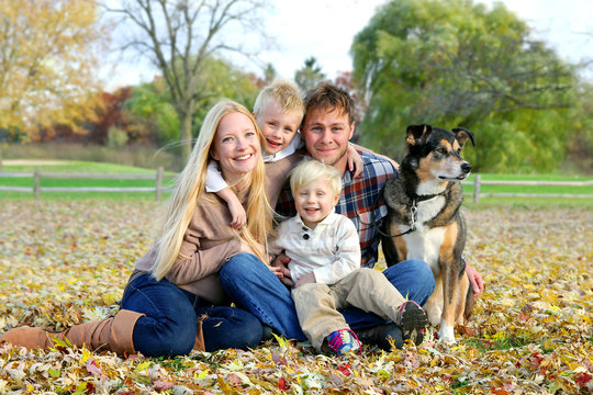 Happy Family and Pet Dog Autumn Portrait