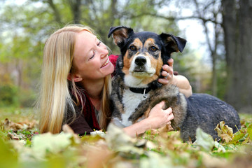Woman Relaxing with her German Shepherd Dog on Fall Day