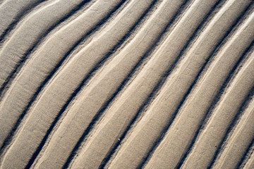 A background texture of unrefined, damp and grainy natural golde