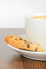 Half cup of coffee with cookies on table