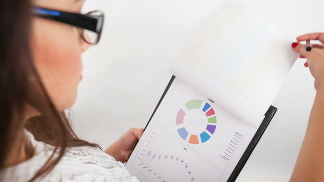 Young business woman with documents in camera view