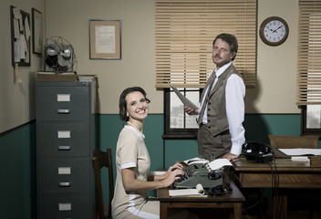 Director and secretary working together in the office