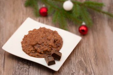 Chocolate rice porridge on wooden background