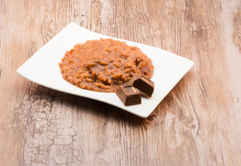 Chocolate rice porridge on wooden background