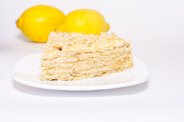 Slice of pie on a white plate decorated with lemons