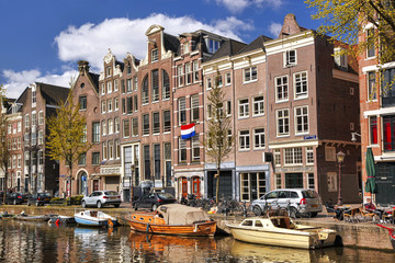 Amsterdam with boats on canal in Holland