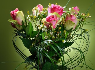 Bouquet of pink roses on green background.