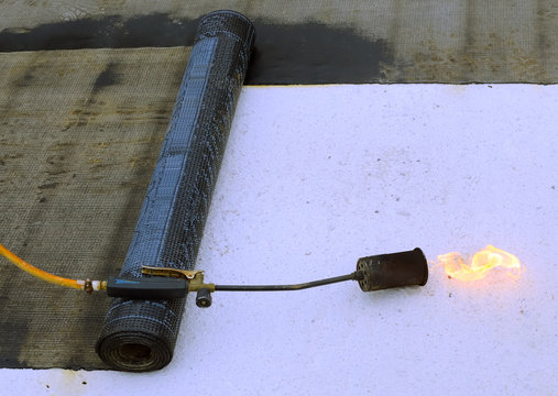 roofing felt roll and one torch blowpipes with open flame