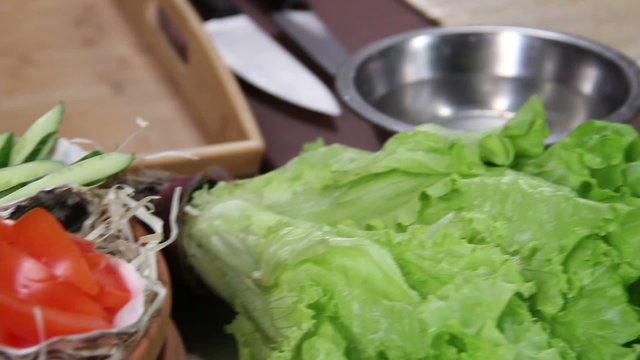 Sushi ingredients on kitchen table, freshly sliced vegetables