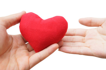 male hand giving a red heart to a female hand