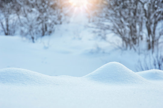 Winter background with a snowdrift and sun