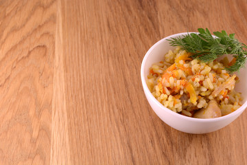 Chinese cuisine - fried rice with meat on wooden background