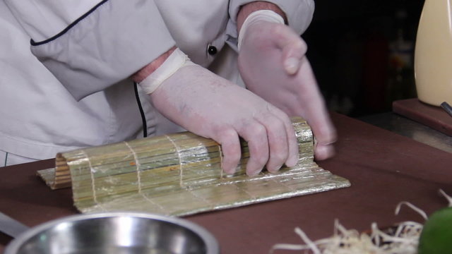 Process of making Japanese sushi rolls with cucumber and caviar