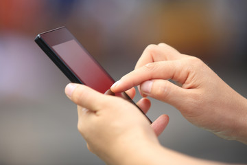 young woman hands use cellphone in city 