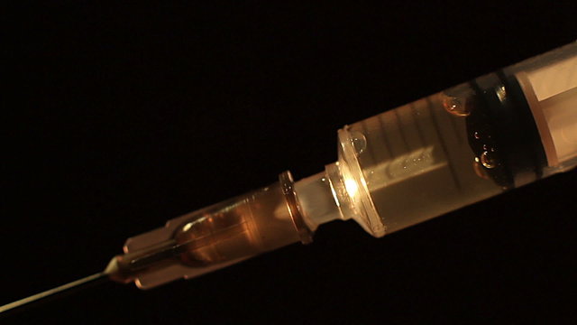Close-up liquid substance in syringe, drug injection, narcotics
