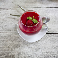 panacotta dessert with ripe raspberries, sprinkled syrup