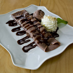 Crape chocolate with banana and chocolate ice cream with topping