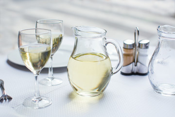 Jug of white wine with two glasses
