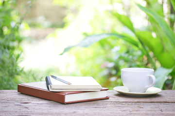Notebook  and coffee on wooden table