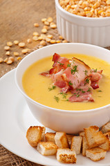 Cream soup of peas with fried bacon and croutons