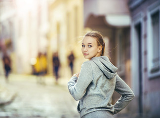 Naklejka na ściany i meble Young woman running in city center