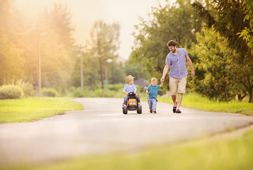 Father with sons have fun on road