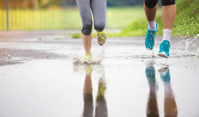 Couple running in rainy weather