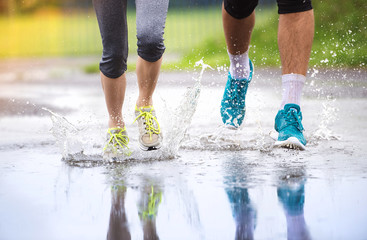 Couple running in rainy weather