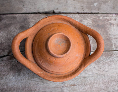 Clay pots on wooden table.