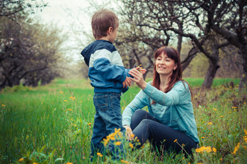 Fototapeta premium mother and son in the flowered garden