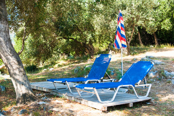 Obraz na płótnie Canvas Sunbeds and umbrellas on the beach in Corfu Island, Greece