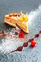 Delicious layered cake with whipper cream on black background