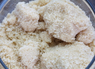 Close - up brown sugar in glass bottle