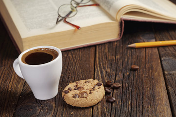 Coffee cup and old book