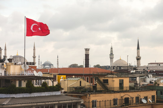 Turkish Flag and Istanbul Rooftops View with Mosque on Backgroun