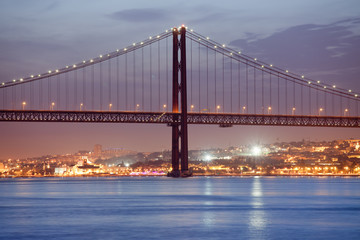 25 de Abril Bridge in Lisbon at Night - Powered by Adobe