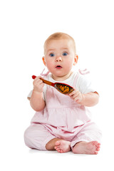 Baby with spoon in hand