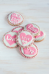 homemade cookies with pink frosting in the shape of hearts