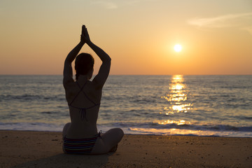 Fototapeta na wymiar Sunset yoga on the beach