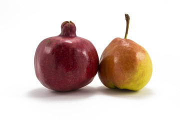 Pomegranate and pear on a white background
