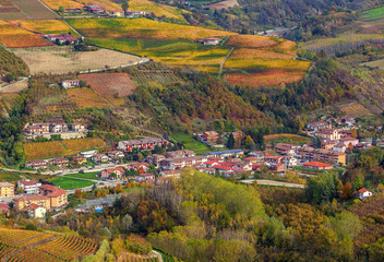 Small town among autumnal hills in Italy.