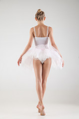 Naklejka premium Ballerina in classical tutu over white background