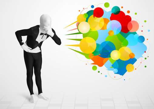 Strange guy in morphsuit looking at colorful speech bubbles