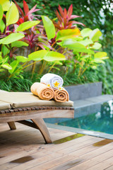 Towels with white frangipani flowers in spa