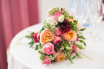 bridal bouquet of roses, buttercups and other flowers